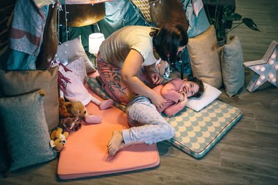 High angle view of woman sitting on sofa at home