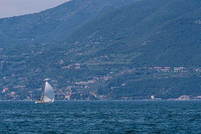 Scenic view of sea and mountains against sky