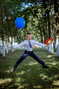 Portrait of boy jumping outdoors