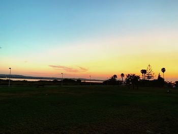 Scenic view of silhouette field against sky during sunset
