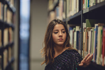 Portrait of young woman reading book