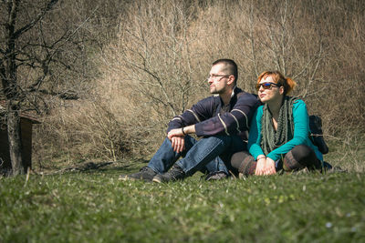 Portrait of a smiling young couple sitting on grass