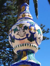 Low angle view of tree against blue sky