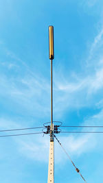 Low angle view of electricity pylon against sky