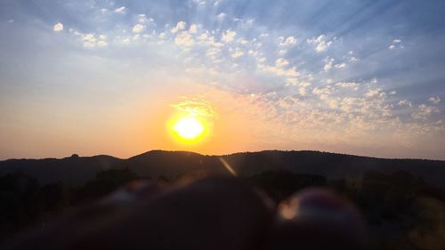 Scenic shot of silhouette mountains at sunset