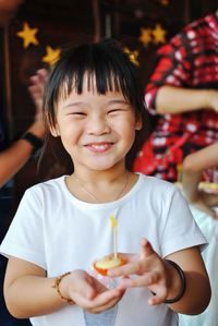 Portrait of a smiling girl holding ice cream