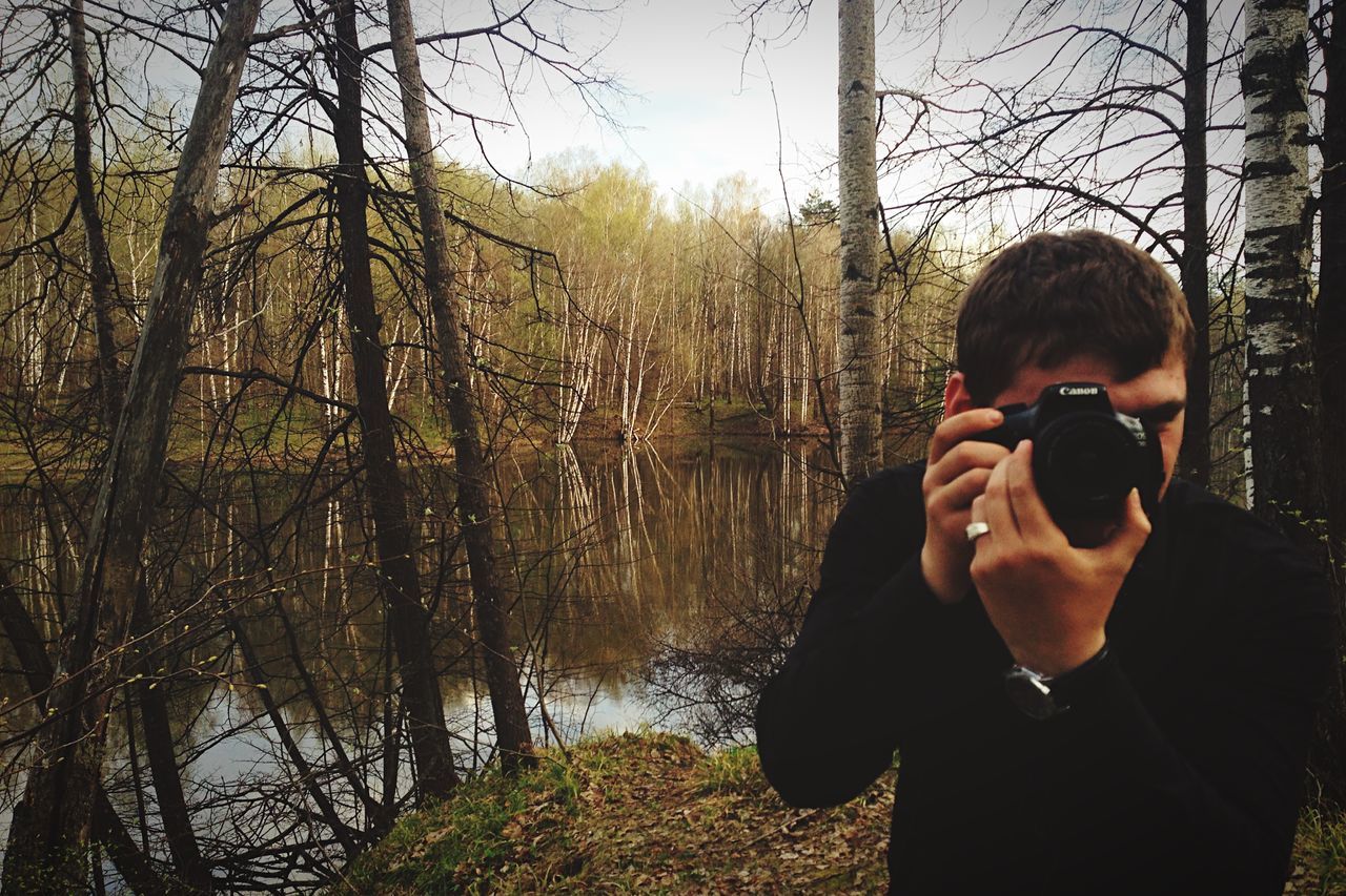 lifestyles, water, leisure activity, tree, person, young adult, reflection, casual clothing, lake, standing, young men, headshot, nature, day, forest, three quarter length, river