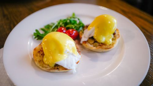 Close-up of eggs benedict in plate on table