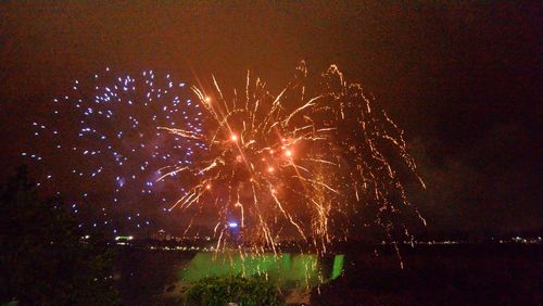 Low angle view of firework display at night