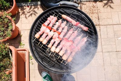 High angle view of meat on barbecue grill