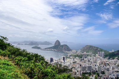 View of cityscape against cloudy sky