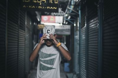 Man in cap standing amidst shutter