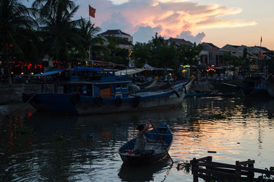 Boats sailing in sea against sky during sunset