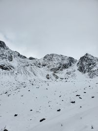 Scenic view of snowcapped mountains against clear sky