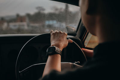 Midsection of man driving car