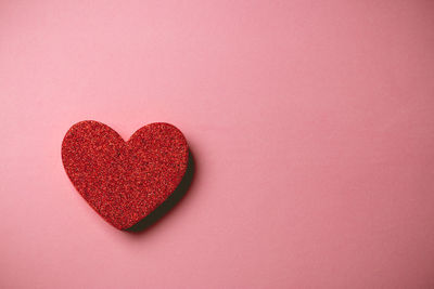 Close-up of heart shape against red background