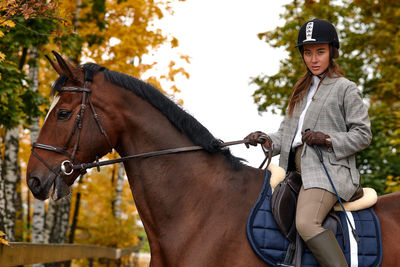 Portrait of young woman with horse