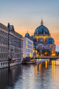 View along the river spree in berlin at dusk with the cathedral in the back