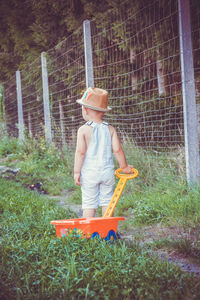 Baby boy pulling trolley