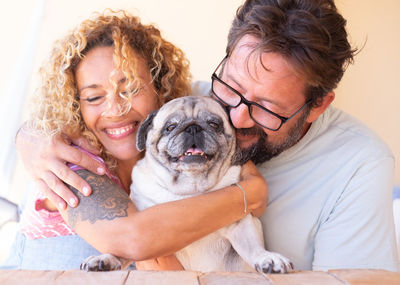 Close-up of couple with dog