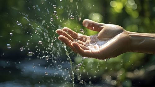 Cropped hand of woman holding water