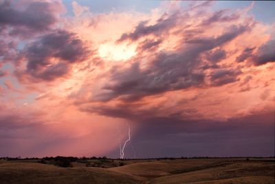 Scenic view of lightning striking field