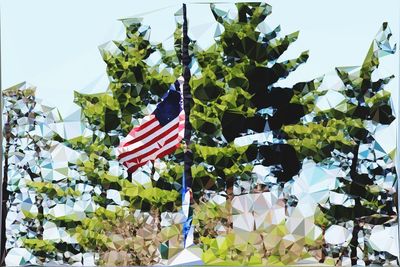 Low angle view of flags against clear sky