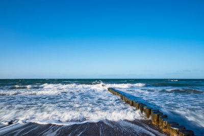 Scenic view of sea against clear blue sky