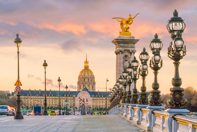 Statue of historic building against sky at sunset