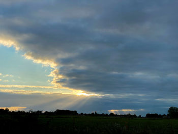 Scenic view of field against sky during sunset