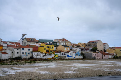 Buildings in town against sky