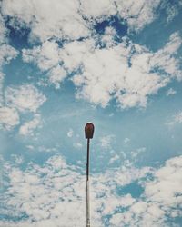 Low angle view of street light against cloudy sky