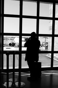 Woman looking through window