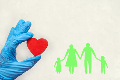 Close-up of man holding multi colored paper