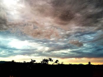 Silhouette of landscape against cloudy sky