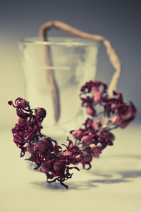 Close-up of red berries on white table