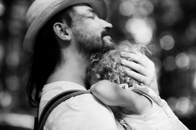 Close-up of father embracing daughter outdoors