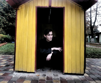 Portrait of a young man sitting outdoors