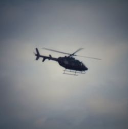 Low angle view of airplane flying against sky