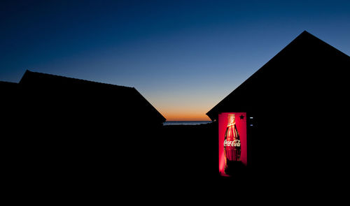 Low angle view of illuminated building against sky at night