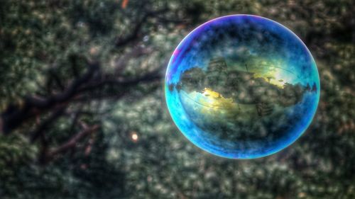 Close-up of bubbles against blue sky