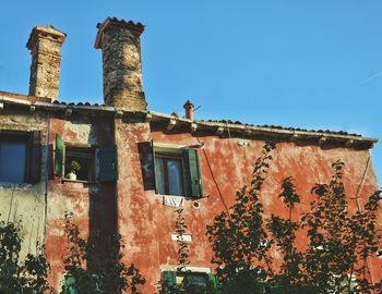 Low angle view of building against clear blue sky