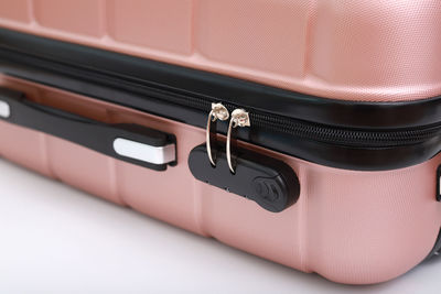 Pink luggage against white background