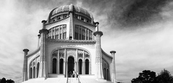 Low angle view of historical building against cloudy sky