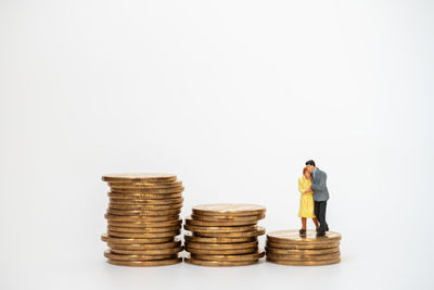 Full length of a stack of two people against white background