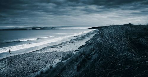 Scenic view of sea against cloudy sky