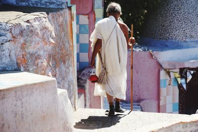 Rear view of man walking on street