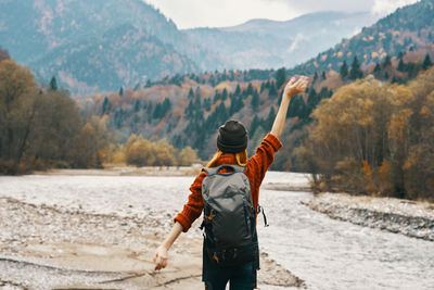 Rear view of man standing on shore