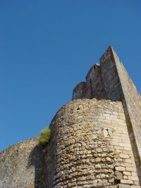 Low angle view of old building against blue sky