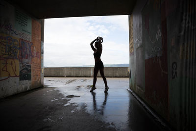 Side view of silhouette man standing on wet floor